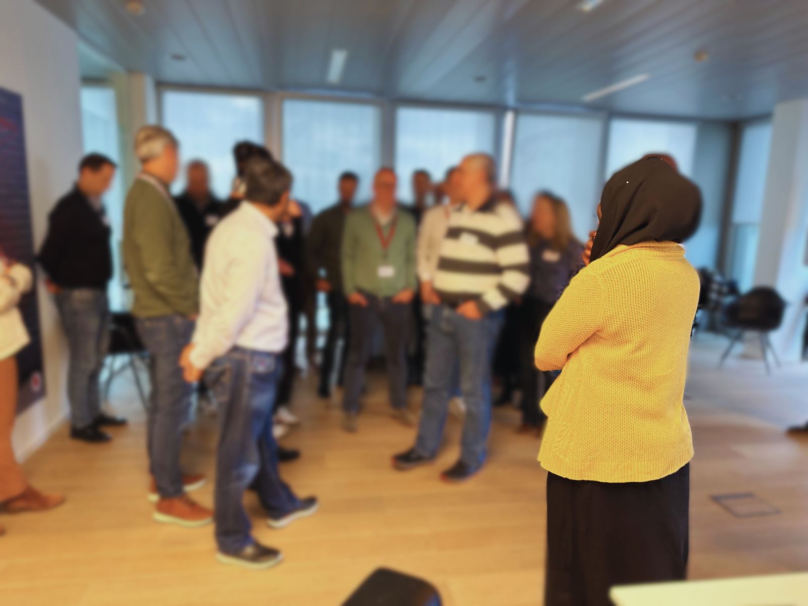 Olayinka standing with a circle of leaders during a workshop exercise