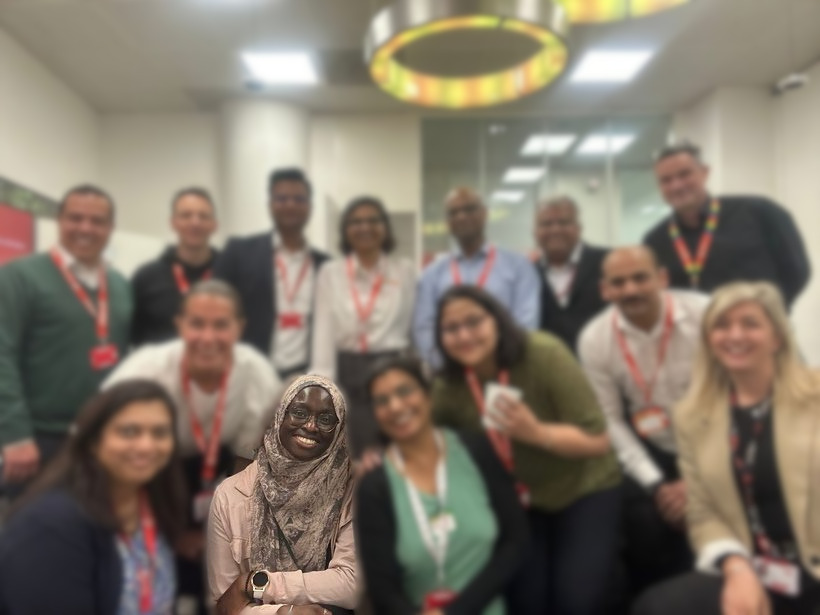 Olayinka with a smiling group of leaders at the end of a workshop